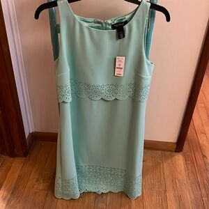Beautiful mint green spring dress with scallop detail at waist and hem.